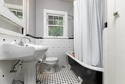 Original Restored Claw Foot Tub/Shower. Built in Cabinet. Old fashioned looking sink & stool. Large laundry closet. Black & white tile floor. Original Steam Heat register for looks only. Forced air furnace is in basement.