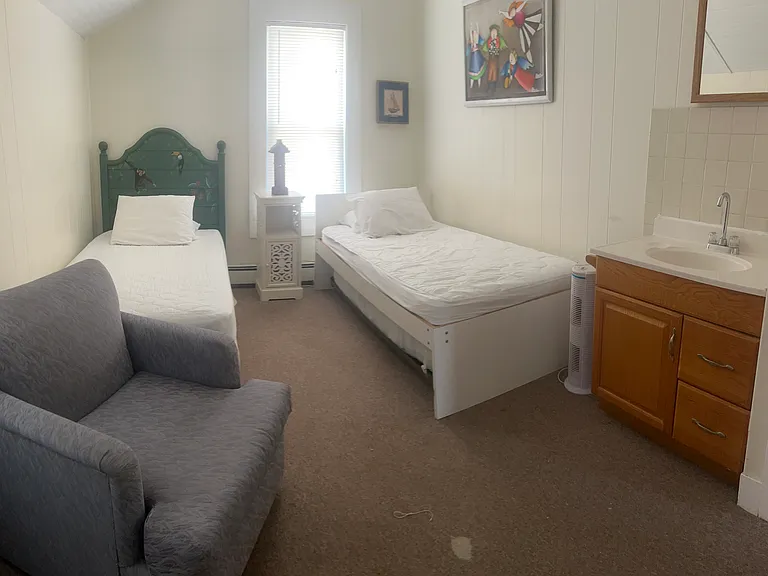Upstairs bedroom with 2 twins and third twin trundle, with sink vanity