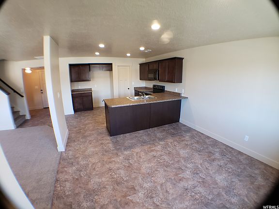 View of dining area, kitchen, and living room with newer LVP and carpet (not pictured).