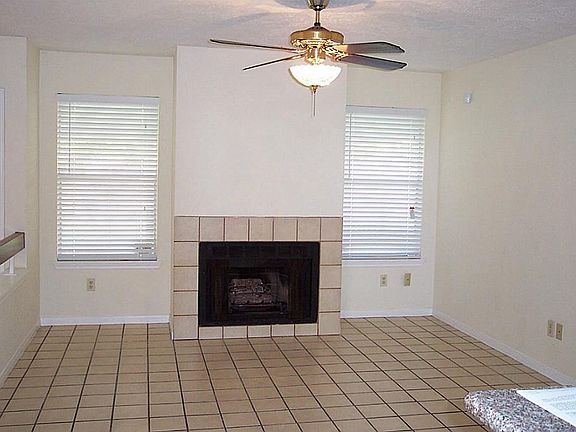 The family room is very open and has a fireplace with gas logs. The tile floor extends from the fami