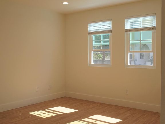 Spacious and bright living space with wood flooring throughout the home