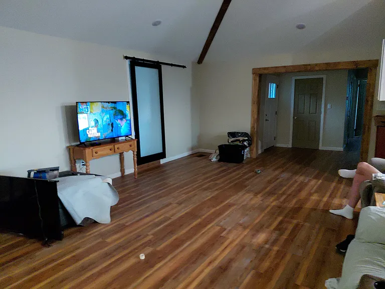 living room looking towards front door entrance and hallway to Br2 and Br3.