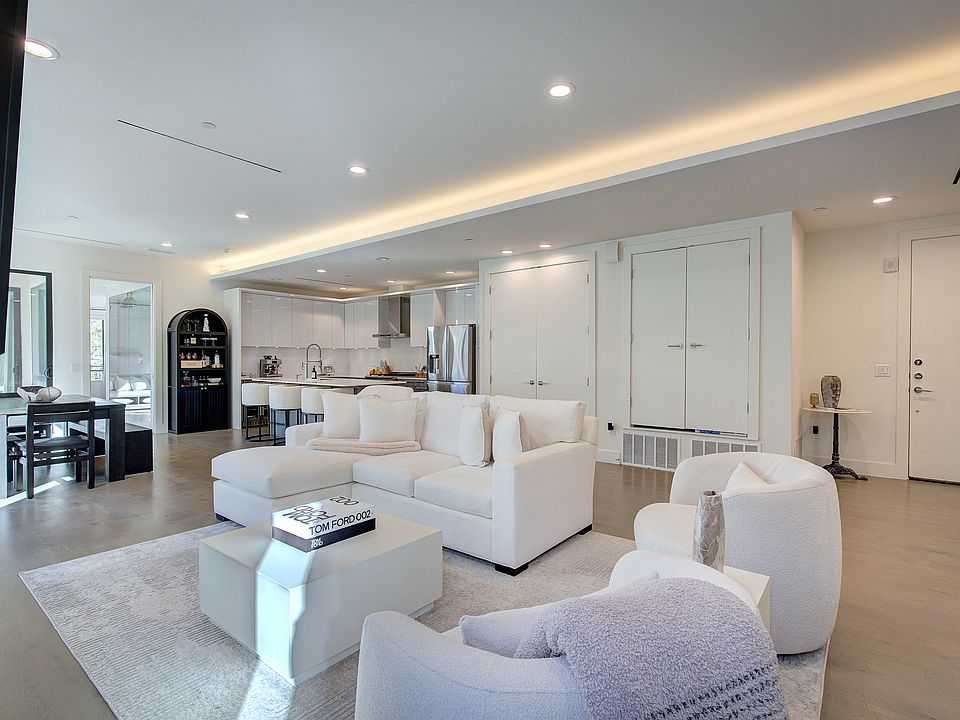 Sophisticated open floor plan with cove lighting and chef's kitchen