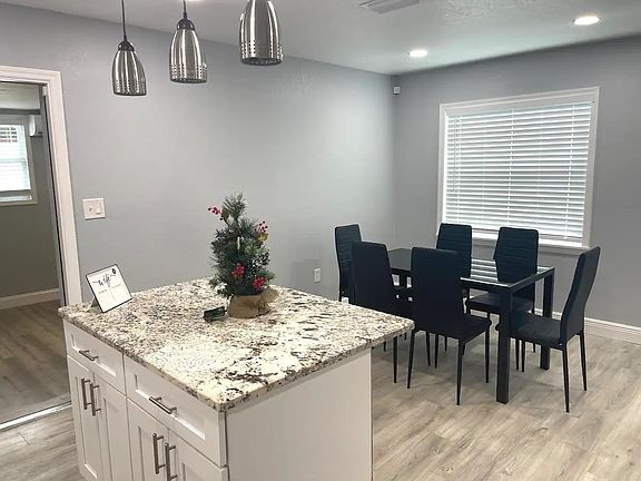 Kitchen island has bar seating, and dining area can accommodate a table for 6 easily, ( dining table and chairs, not included)