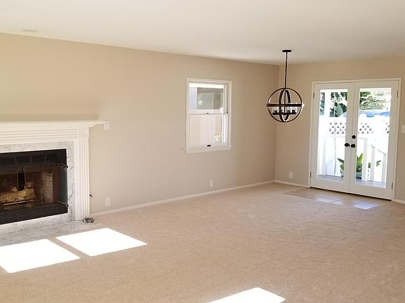 Living Room with Dining Area. French Doors lead to private Back Patio.
