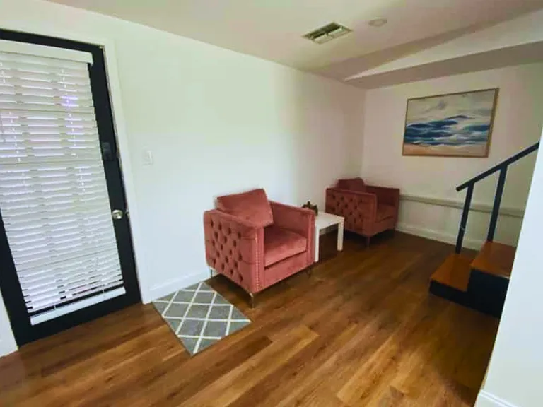 Two inviting armchairs and a coffee table create the perfect relaxation spot.