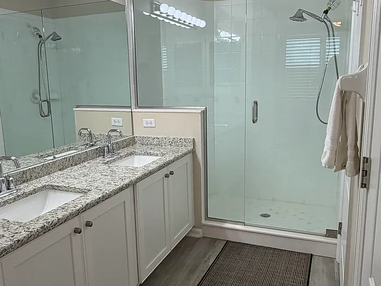 Upgraded (new) cabinets, granite, sinks and faucet. All glass shower doors. Premium vinyl flooring throughout including large walk-in closet.