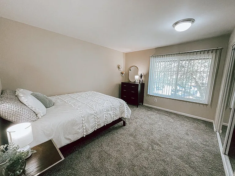 Carpeted Bedroom with Window and Closet