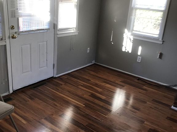 Den with a side door to the backyard porch