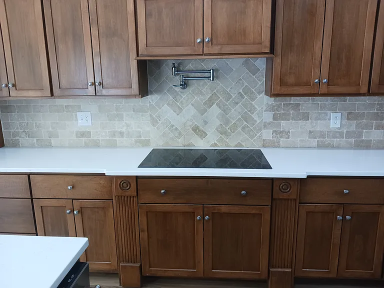Induction cooktop with pot-filler faucet