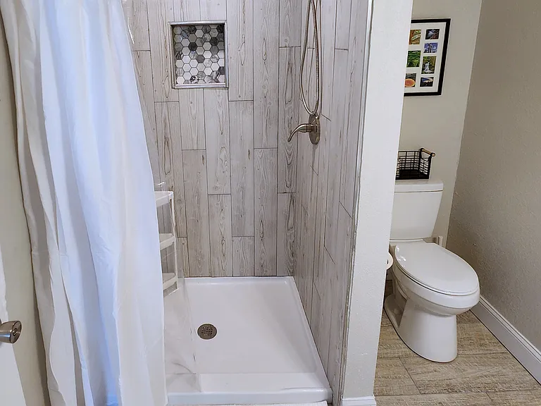 Spacious bathroom with oversized shower and vanity for storage