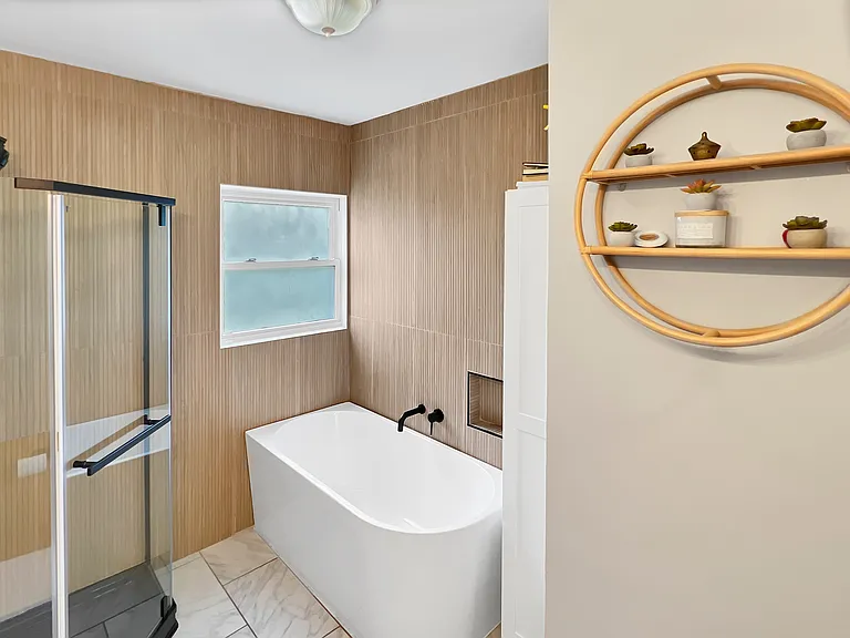 Japanese-inspired bathroom with tub and shower.