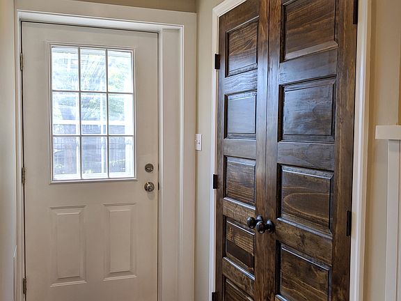 Entryway with Stylish Storage Closet Doors.