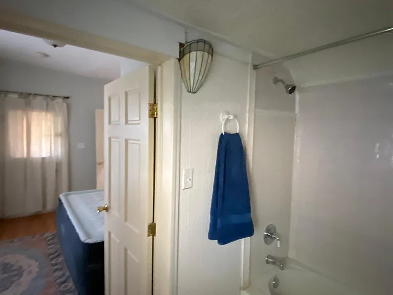 The shower and bath in the first bedroom's attached bathroom