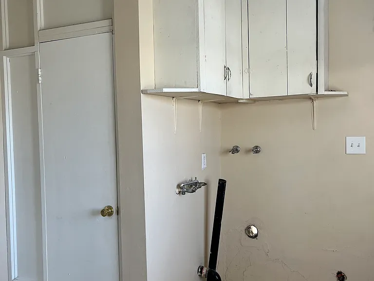 Washer dryer hookups and cabinets also door to back restroom