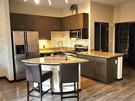 Walk-in closet is located behind the kitchen area (door on left)