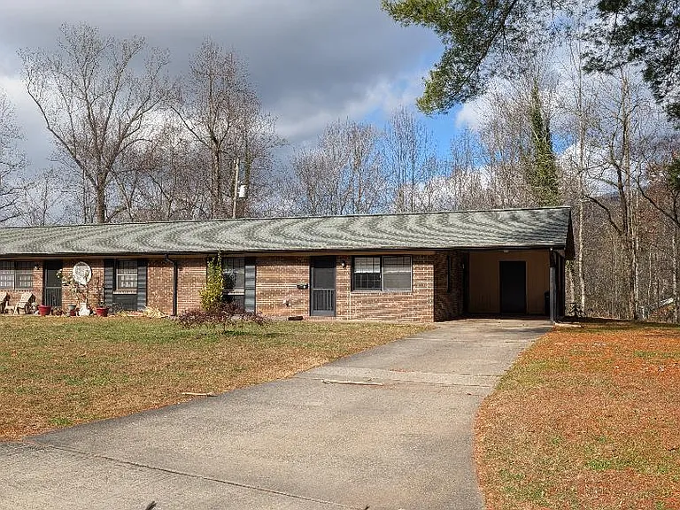 ENTRANCE WITH CARPORT, STORAGE AREA AND LARGE YARD