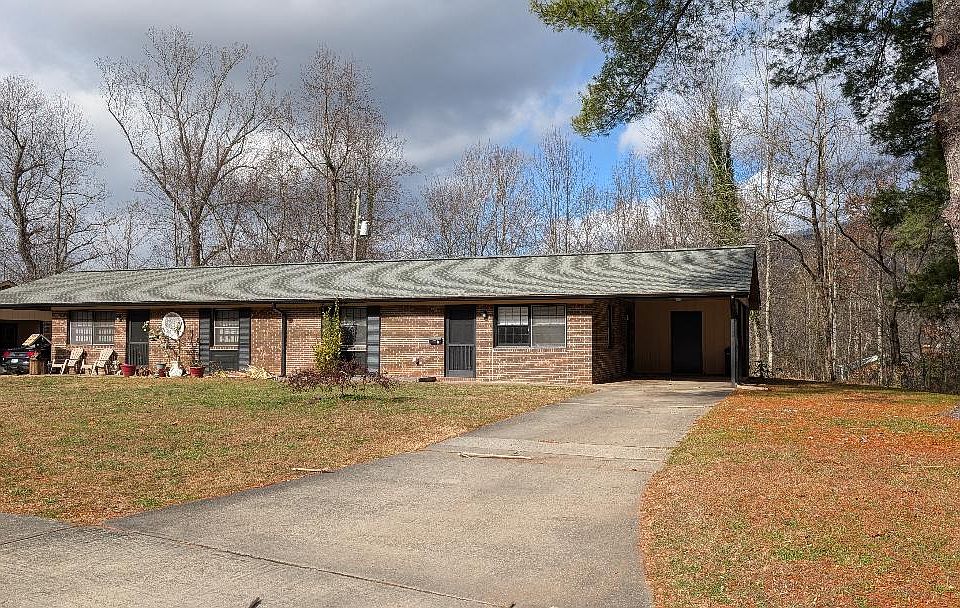 ENTRANCE WITH CARPORT, STORAGE AREA AND LARGE YARD
