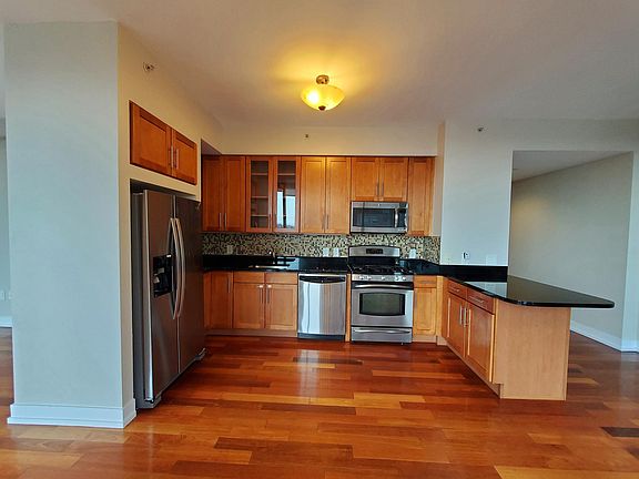 Elegant open-floor layout kitchen with stainless steel appliances