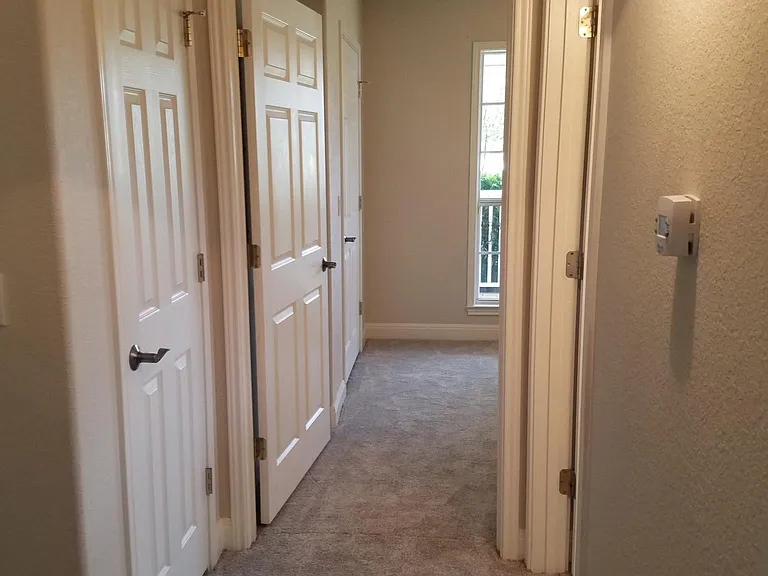 Hallway from Master to 2nd bedroom and hall bath. Note large linen closet to left.