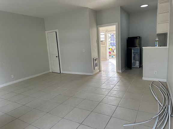 Bedroom to the rear of apartment. New in wall heater, new fridge and kitchen, new window a/c with heat. Back patio just off the bedroom/back door. bathroom just before the back door to right in bedroom.