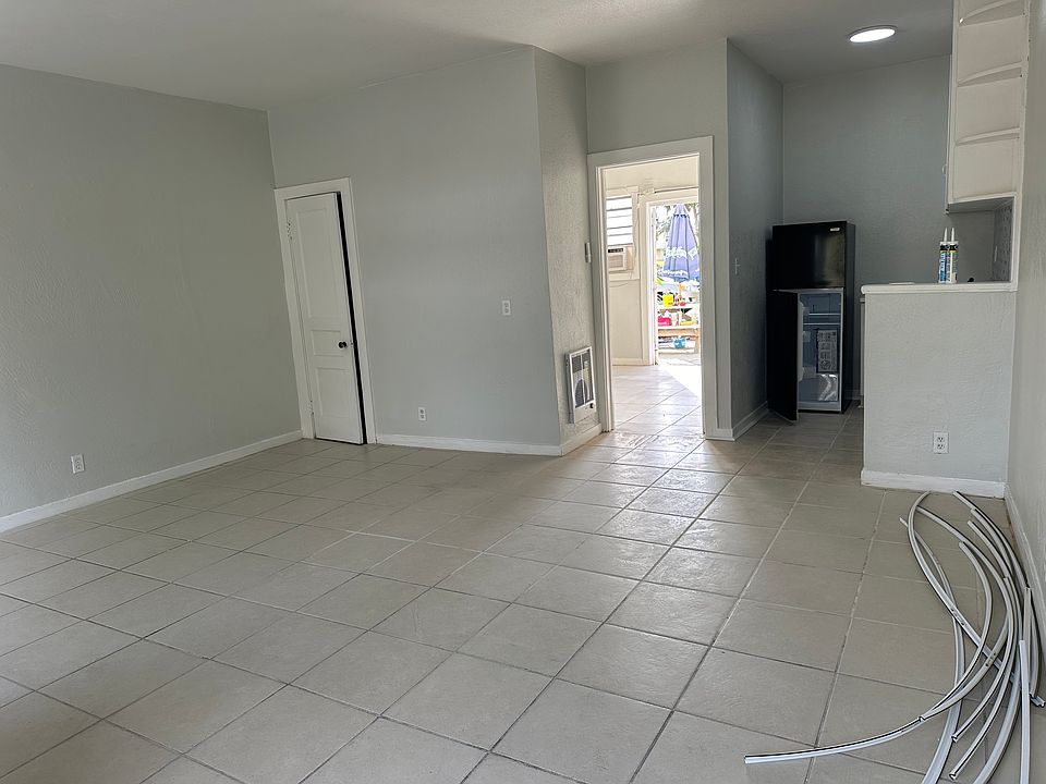 Bedroom to the rear of apartment. New in wall heater, new fridge and kitchen, new window a/c with heat. Back patio just off the bedroom/back door. bathroom just before the back door to right in bedroom.