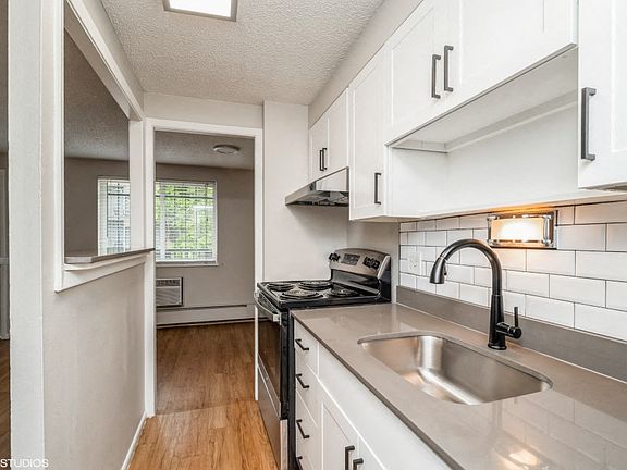 Renovated kitchen with granite countertops and white cabinetry