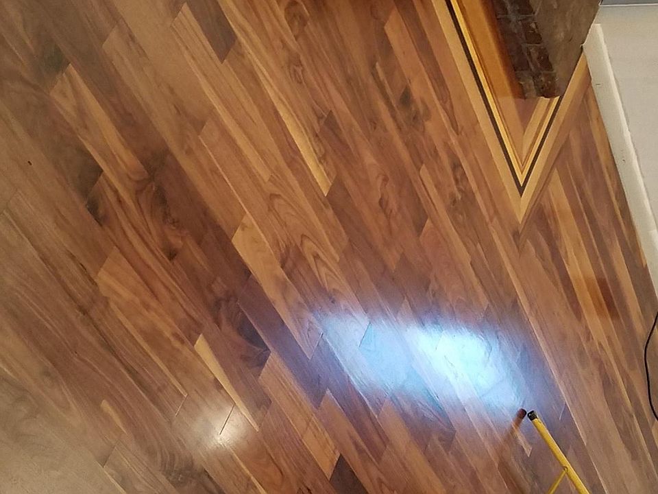 Living room, around fireplace is Black Walnut, Quarter Saw Oak then Zebra wood (Africa), Yellow Heart wood (Brazil), Wingee (Asia), back into Quater Saw Oak, continuing into the Black Walnut. W design in center. Built by master craftsmen w newly finished