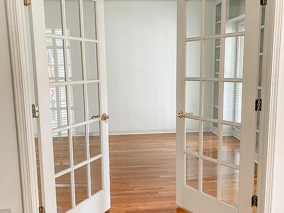 Office with built in shelving and dual french doors