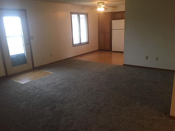 Large living room with door that leads to deck