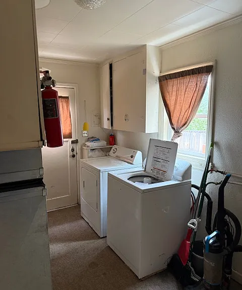 Full Laundry room with vacuum, ironing board and iron.