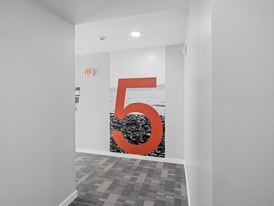 This room features a bold and unique design with a large red number 5 on the wall, adding character to the space.
