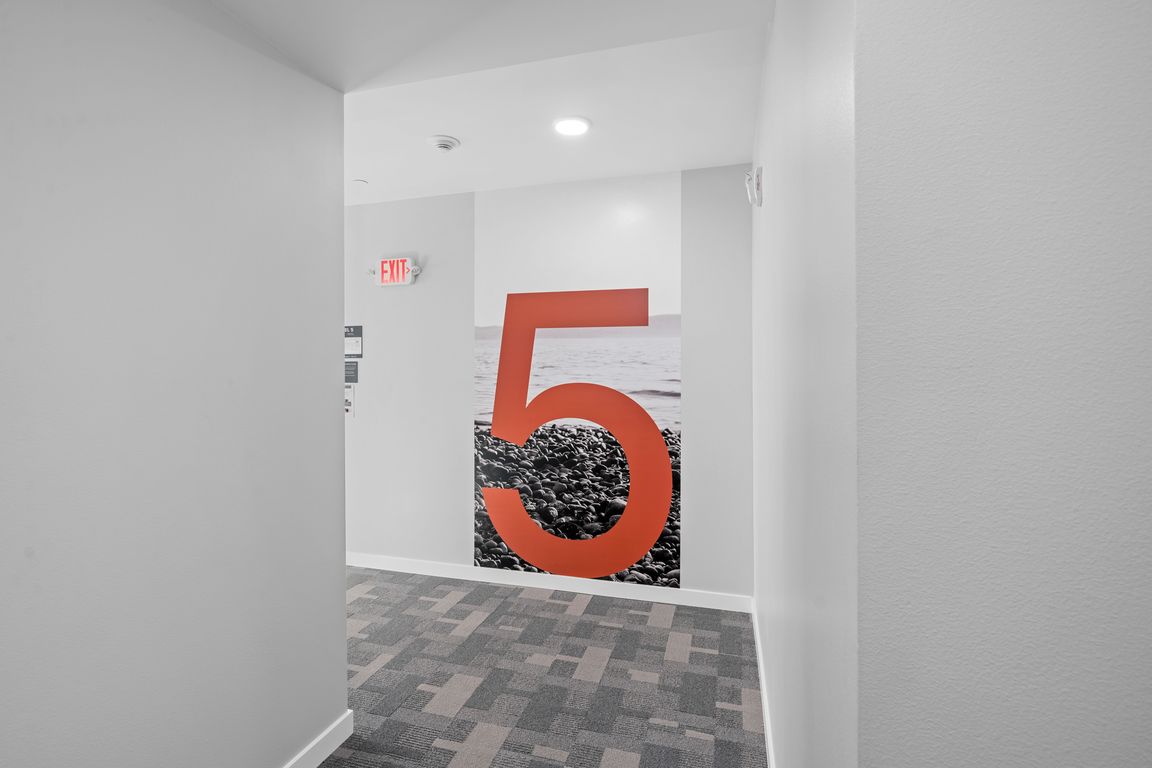 This room features a bold and unique design with a large red number 5 on the wall, adding character to the space.