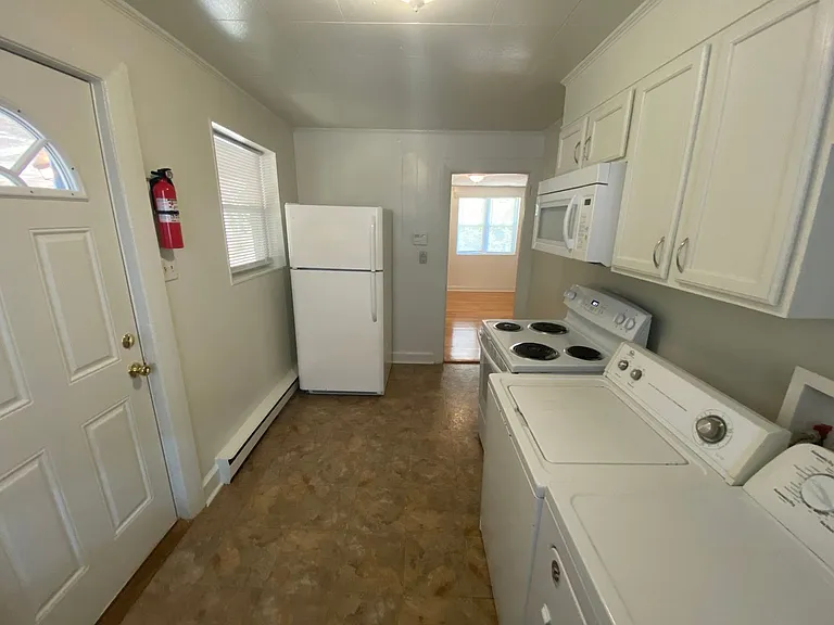 Private carport, in-unit laundry, and the Lakewood strip right outside your door. — Photo 7