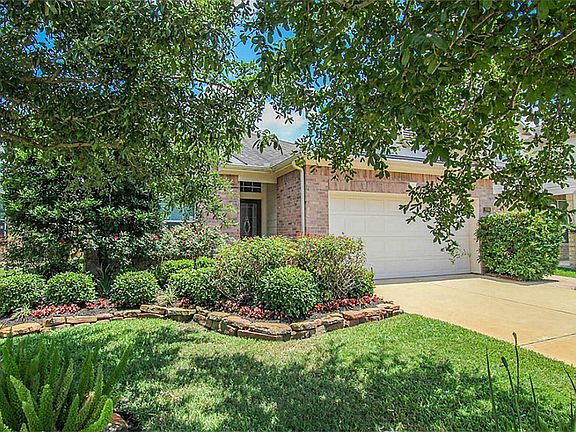 Another view of the landscaping and the beautiful brick exterior of the home.
