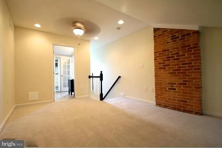 3rd floor: Master Bedroom at front of house looking towards rear of house. Door to bedroom is at the foot of the stairs. Ensuite bathroom and closet to left of stairs.
