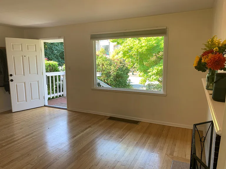 Entry into large, sunny living room with fireplace