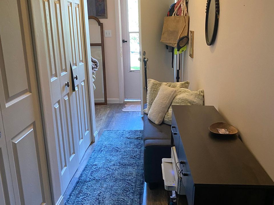 Hallway to front door and basement door where the laundry is.