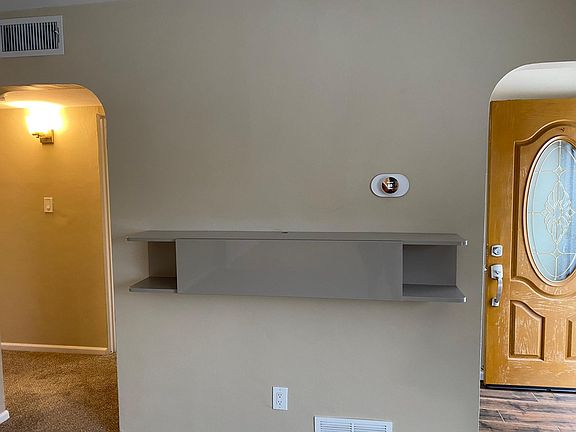 Nest thermostat, TV stand with shelving.
