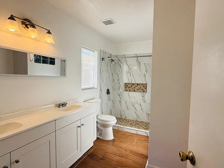Bathrooms with double vanity sinks and an inviting shower.