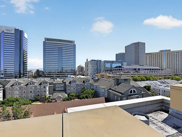 Rooftop city view overlooking downtown Oakland and nearby Old Oakland buildings.
