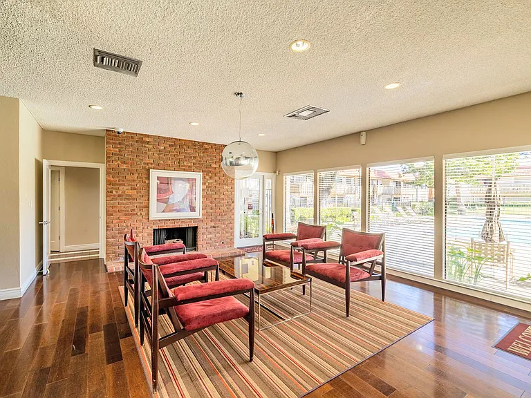 Inviting resident lounge with ample seating and a fireplace.