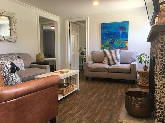 Living room basic cable TV wood burning fireplace