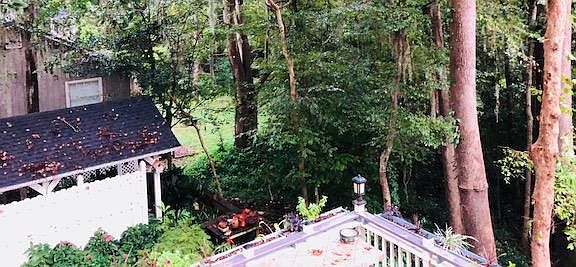 view of carport roof , private garden and path to outer buil