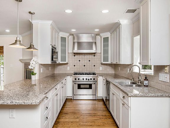 Updated open kitchen leads directly to patio for easy entertaining and to living room. All stainless steel appliances included.