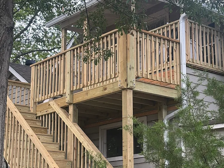 New deck and porch overlooking large backyard.