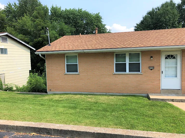 Small front yard. left hand side of the duplex.