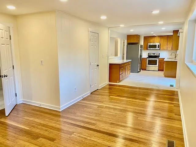 Family room with wood flooring opening to recently remodeled kitchen area