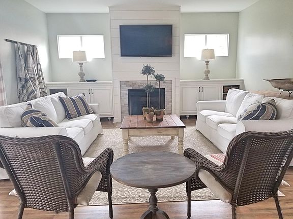 Open living room with beautiful tile fireplace and custom bu
