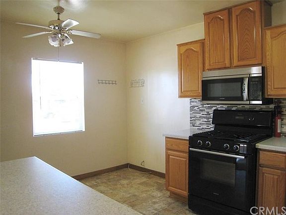 View of the Kitchen and Eating Area from the Pass-Thru with it's Corian Countertop.  Ceiling helps keep the kitchen cooler